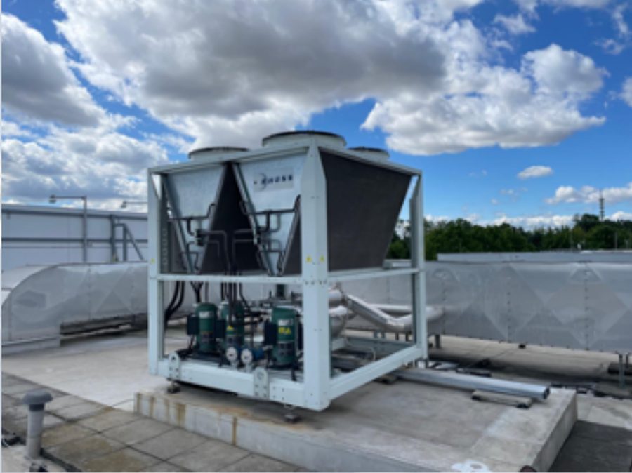A rooftop air-cooled chiller on a flat roof